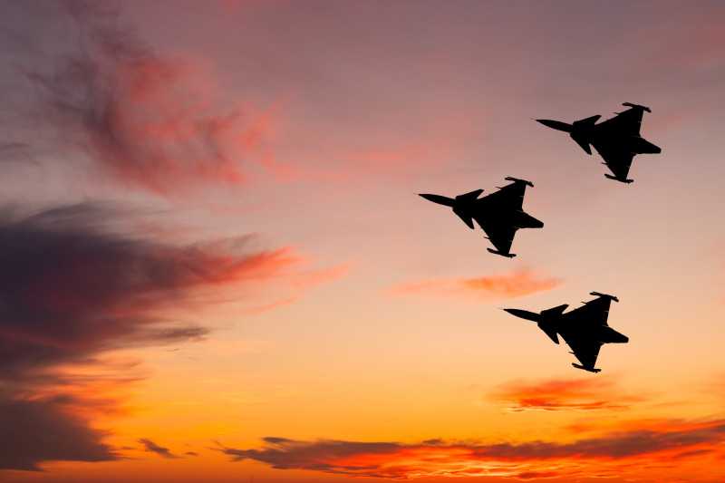 Swedish fighter jet in the sky at sunset