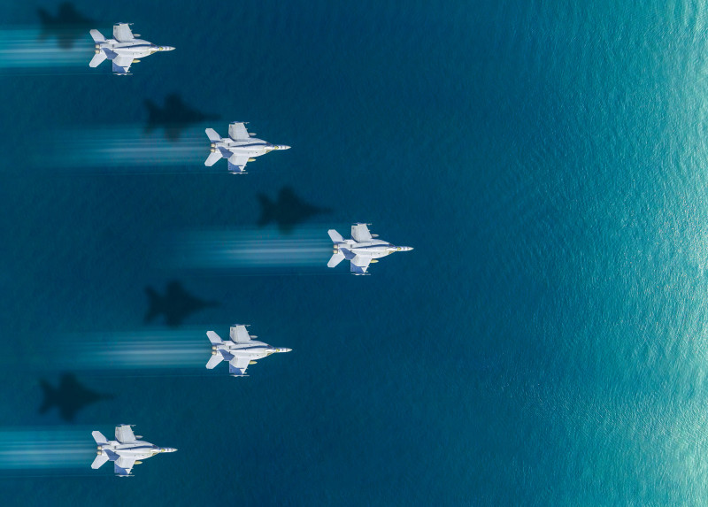 Air force flying over the sea. The concept of war and international territorial defense.